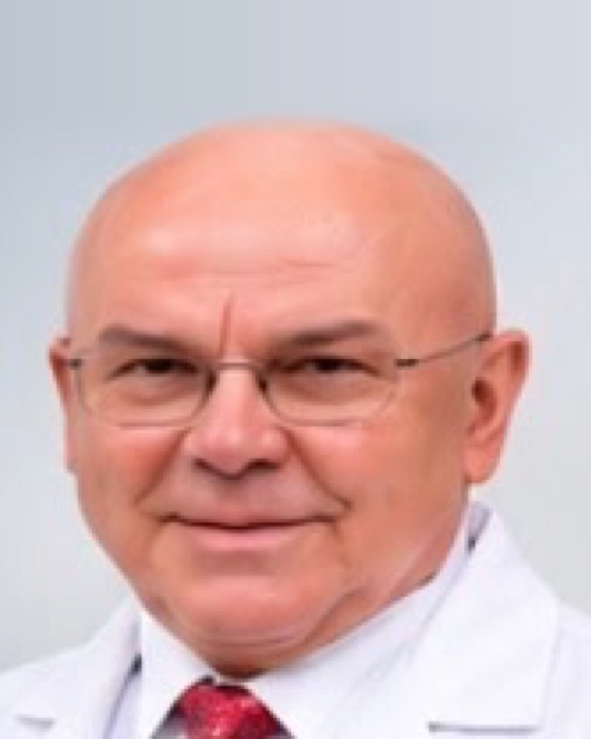 Portrait of Dr. Januariusz Styperek in a white coat